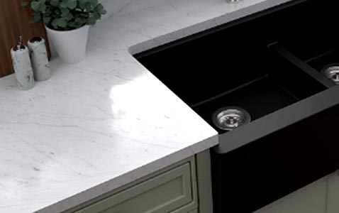 Granite composite black kitchen sink on a quartz countertop