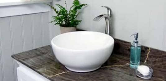 A white vessel sink on the counter top
