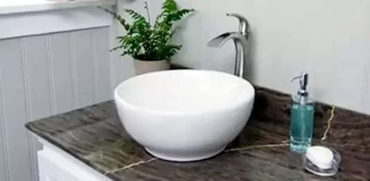 A white vessel sink on a counter top